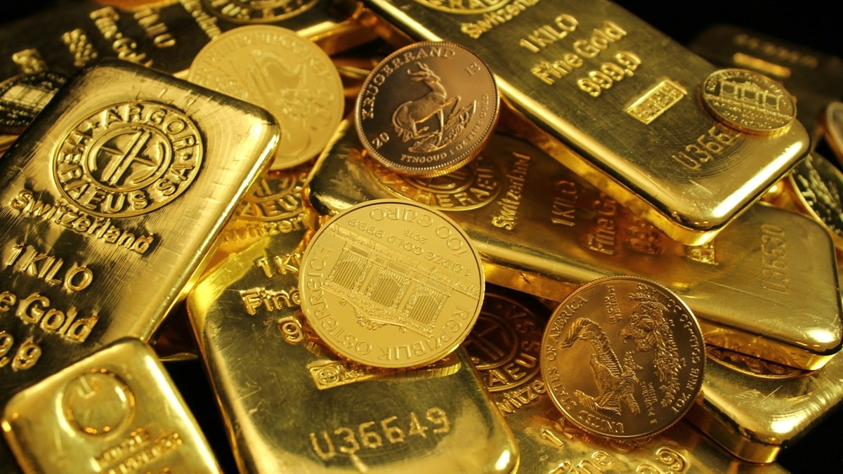 gold coins and bars in a pile