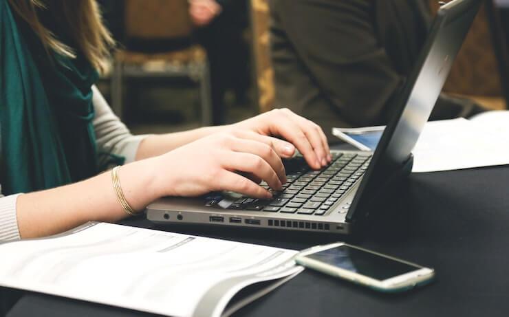 Woman working at a restaurant on her laptop